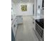 Bright kitchen featuring gray tile floor, white cabinets, and stainless steel appliances at 5608 Larimer Dr, Tampa, FL 33615