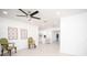 Inviting living room with tile floors, ceiling fan, and view into the modern kitchen at 5608 Larimer Dr, Tampa, FL 33615