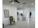 A modern living room and open kitchen featuring white tile floors and neutral tones at 5608 Larimer Dr, Tampa, FL 33615