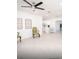 Bright, open-plan living space with tile flooring, fan, and modern furnishings at 5608 Larimer Dr, Tampa, FL 33615