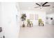 Bright living area showcasing tile floors, a ceiling fan, and a view into the modern kitchen at 5608 Larimer Dr, Tampa, FL 33615