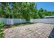 Large, flat backyard with a patio and white fence at 5865 Meadowpark Pl, Lithia, FL 33547