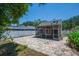 Relaxing backyard featuring screened in porch and brick paver patio surrounded by a white vinyl fence at 5865 Meadowpark Pl, Lithia, FL 33547