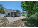 Backyard features a patio, screened-in patio, white fence, and mature trees at 5865 Meadowpark Pl, Lithia, FL 33547