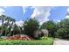 Community entrance with a decorative fountain and mature landscaping at 5865 Meadowpark Pl, Lithia, FL 33547