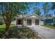 Charming single-story home featuring a well-manicured lawn and welcoming curb appeal with black framed garage doors at 5865 Meadowpark Pl, Lithia, FL 33547