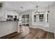 Bright kitchen showcasing stainless steel appliances, breakfast bar, and sliding doors to outdoor living at 5865 Meadowpark Pl, Lithia, FL 33547