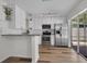 Open concept kitchen with stainless steel appliances, breakfast bar and modern cabinets at 5865 Meadowpark Pl, Lithia, FL 33547
