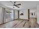 Open-concept living room featuring hardwood flooring, large windows, and decorative wood paneled accent walls at 5865 Meadowpark Pl, Lithia, FL 33547