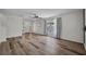 Spacious living room with hardwood floors, large bright windows, and neutral paint at 5865 Meadowpark Pl, Lithia, FL 33547
