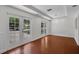 Bright living room boasts hardwood floors, recessed lighting, and access to the outdoors through double French doors at 5865 Meadowpark Pl, Lithia, FL 33547