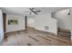 Open living room space with hard wood floors, bright lighting, and neutral paint at 5865 Meadowpark Pl, Lithia, FL 33547
