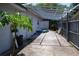 Backyard patio under wooden pergola with a small papaya tree at 6326 55Th N Ave, St Petersburg, FL 33709