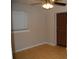 This bedroom features light-colored walls, wood floors, ceiling fan, and a window with horizontal blinds at 6326 55Th N Ave, St Petersburg, FL 33709