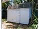 Exterior view of backyard white storage shed with shingled roof at 6326 55Th N Ave, St Petersburg, FL 33709