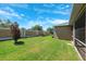 Well-maintained backyard featuring green lawn, privacy fence, and views of the home at 6547 Castle Green Pl, Zephyrhills, FL 33541