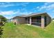 Spacious backyard with lush lawn, a screened patio, and mature landscaping at 6547 Castle Green Pl, Zephyrhills, FL 33541