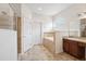 Bathroom featuring a separate shower and tub, a vanity with sink, and tiled floors and walls at 6547 Castle Green Pl, Zephyrhills, FL 33541