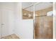 Bathroom featuring tiled shower with glass doors and decorative mosaic tile accents at 6547 Castle Green Pl, Zephyrhills, FL 33541