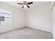 Bright bedroom with a ceiling fan, a window, carpet flooring, and a closet at 6547 Castle Green Pl, Zephyrhills, FL 33541