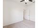 Carpeted bedroom features a ceiling fan and a door to the walk-in closet at 6547 Castle Green Pl, Zephyrhills, FL 33541