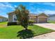 Charming one-story residence displays a well-kept lawn and a convenient three-car garage at 6547 Castle Green Pl, Zephyrhills, FL 33541