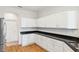 Modern kitchen featuring stainless steel appliances, granite countertops, and bright white cabinetry at 6547 Castle Green Pl, Zephyrhills, FL 33541