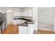 Modern kitchen featuring stainless steel appliances, granite countertops, and bright white cabinetry at 6547 Castle Green Pl, Zephyrhills, FL 33541