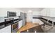 Modern kitchen featuring stainless steel appliances, granite countertops, and bright white cabinetry at 6547 Castle Green Pl, Zephyrhills, FL 33541