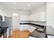 Modern kitchen featuring stainless steel appliances, granite countertops, and bright white cabinetry at 6547 Castle Green Pl, Zephyrhills, FL 33541