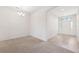 Bright living room with carpet and tile flooring, a chandelier, and a front door with glass inserts at 6547 Castle Green Pl, Zephyrhills, FL 33541