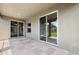 Covered patio with tile flooring and large sliding glass doors to the backyard at 6547 Castle Green Pl, Zephyrhills, FL 33541