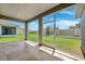 Screened patio with travertine tile flooring and beautiful views of the backyard at 6547 Castle Green Pl, Zephyrhills, FL 33541