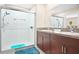 A well-appointed bathroom with a double vanity, granite countertop, and tiled walk-in shower at 742 8Th Nw St, Ruskin, FL 33570