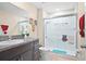 Bright bathroom featuring a granite countertop vanity and glass-enclosed shower at 742 8Th Nw St, Ruskin, FL 33570