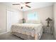 Cozy bedroom with ceiling fan, carpet, closet, window, and lamps on either side of the bed at 742 8Th Nw St, Ruskin, FL 33570