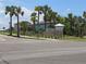 View of the Shell Cove community sign surrounded by lush landscaping and mature palm trees at 742 8Th Nw St, Ruskin, FL 33570