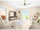 Bright and airy living room featuring neutral decor, tile flooring, and sliding glass doors to the yard at 742 8Th Nw St, Ruskin, FL 33570