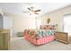 Inviting main bedroom with a ceiling fan, plush carpet and view of the outside at 742 8Th Nw St, Ruskin, FL 33570