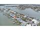 Breathtaking aerial view of waterfront homes with boat docks and lush tropical landscaping at 811 Bay Point Dr, Madeira Beach, FL 33708
