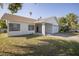 Beautiful single-Gathering home featuring a well-manicured lawn and an attached one car garage at 811 Bay Point Dr, Madeira Beach, FL 33708