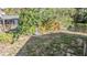 The backyard with minimal grass features partial fencing and a charming shed in the background at 8317 N Marks St, Tampa, FL 33604