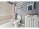 Bathroom showcasing a tiled shower/tub combination, a toilet, and a vanity with sink at 8317 N Marks St, Tampa, FL 33604