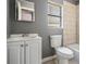 Bathroom featuring a vanity with sink, toilet, and a tiled shower and tub combination at 8317 N Marks St, Tampa, FL 33604