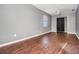 Spacious bedroom featuring wood-look flooring, a ceiling fan, and a closet with black-out curtains at 8317 N Marks St, Tampa, FL 33604