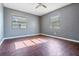 Bright bedroom with wood-look flooring and two windows offering plenty of natural light at 8317 N Marks St, Tampa, FL 33604