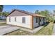 Exterior view of home showing siding, windows, and driveway at 8317 N Marks St, Tampa, FL 33604