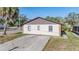 Front exterior view showing a driveway and a brown roof at 8317 N Marks St, Tampa, FL 33604