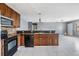 Kitchen featuring granite counters, stainless fridge, and tile floor at 8317 N Marks St, Tampa, FL 33604