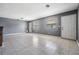 Spacious living room with neutral gray walls and tile floors at 8317 N Marks St, Tampa, FL 33604